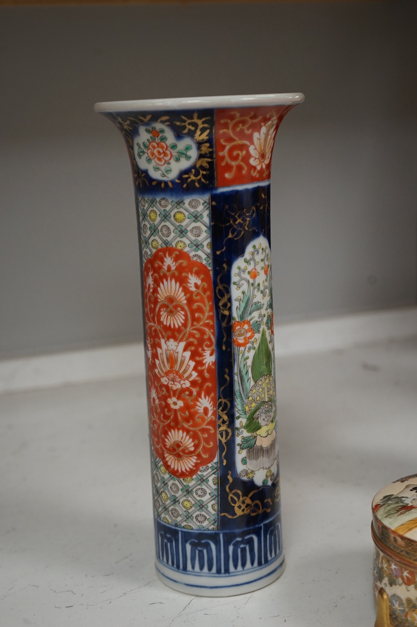 A Japanese Satsuma circular box and cover, a similar vase and an Imari sleeve vase, largest 30cm high. Condition - sleeve vase cracked, others good